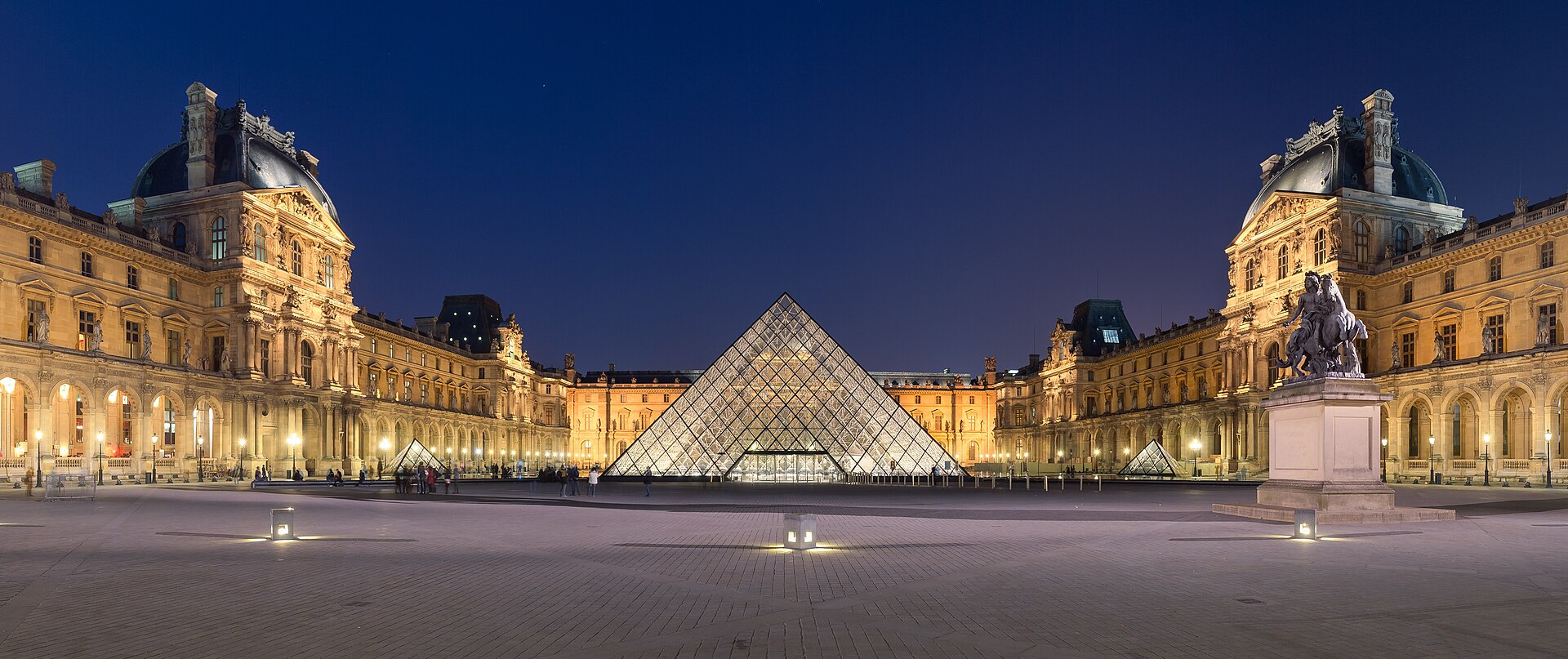 Piramide do Louvre com fachadas historicas ao fundo